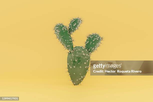 close-up of prickly pear cactus plant against yellow background - cactus stock-fotos und bilder