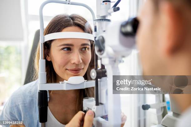 beautiful woman on eyesight exam ,checking the eye - eye exam stockfoto's en -beelden