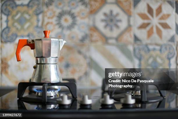 moka pot maker on gas stove - gas cooking stock-fotos und bilder