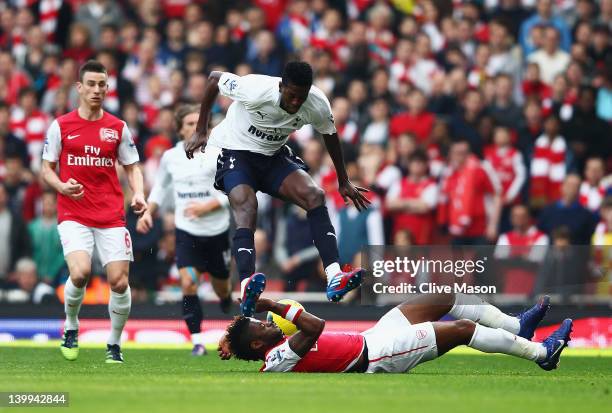 Emmanuel Adebayor of Tottenham Hotspur evades a challenge by Alex Song of Arsenal during the Barclays Premier League match between Arsenal and...