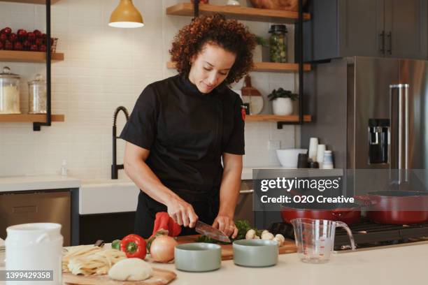 professional chef at work in a kitchen - black jacket stock pictures, royalty-free photos & images