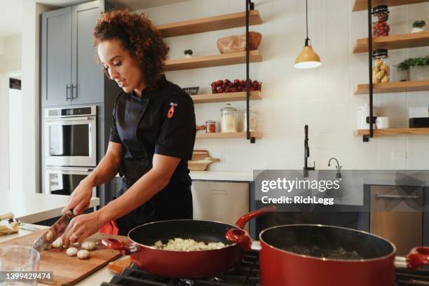 professional chef at work in a kitchen - chef coat stock pictures, royalty-free photos & images