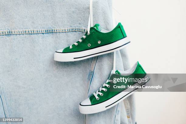 basic clothes stylish outfit. denim jacket and sneakers ready to wear. - groene schoen stockfoto's en -beelden