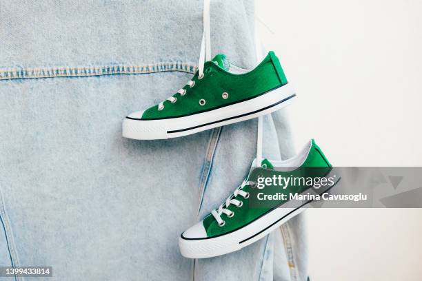 basic clothes stylish outfit. denim jacket and sneakers ready to wear. - green shoe stock pictures, royalty-free photos & images