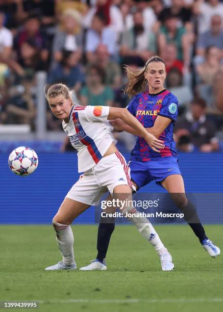 Ada Hegerberg of Lyon tussles with Irene Paredes of FC Barcelona during the UEFA Women's Champions League final match between FC Barcelona and...