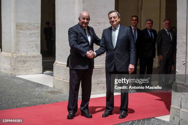Italian Prime Minister Mario Draghi and Algerian President Abdelmadjid Tebboune shake hands before their meeting at Palazzo Chigi, on May 26, 2022 in...
