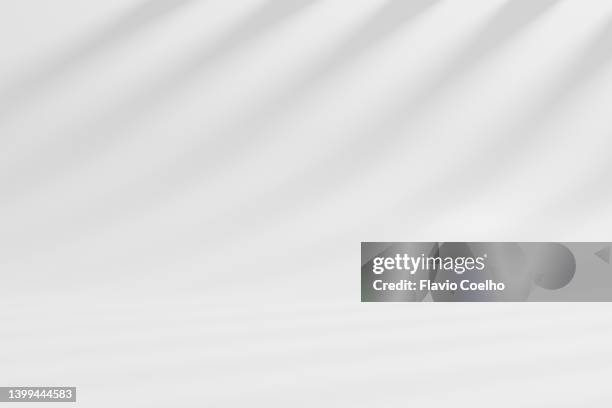studio white background with low contrast gobo lighting - gobo lighting stock pictures, royalty-free photos & images