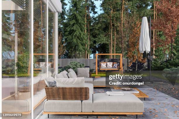 patio with corner sofa, coffee table and garden view - swing chair stock pictures, royalty-free photos & images