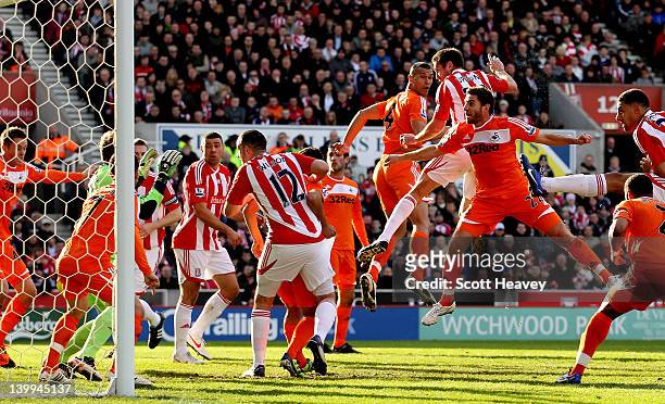 Matthew Upson of Stoke scores their first goal during the Barclays Premier League match between Stoke City and Swansea City at Britannia Stadium on...