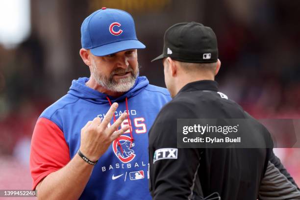 Manager David Ross of the Chicago Cubs argues with umpire Will Little after being ejected in the seventh inning against the Cincinnati Reds at Great...