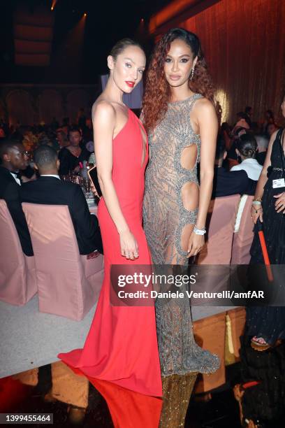Candice Swanepoel and Joan Smalls pose during the amfAR Cannes Gala 2022 at Hotel du Cap-Eden-Roc on May 26, 2022 in Cap d'Antibes, France.