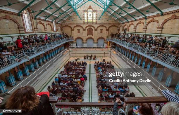 The Bloomsbury String Quartet perform in the empty swimming pool during the Vivaldi And Mozart Candlelit Concert At Victoria Baths on May 26, 2022 in...