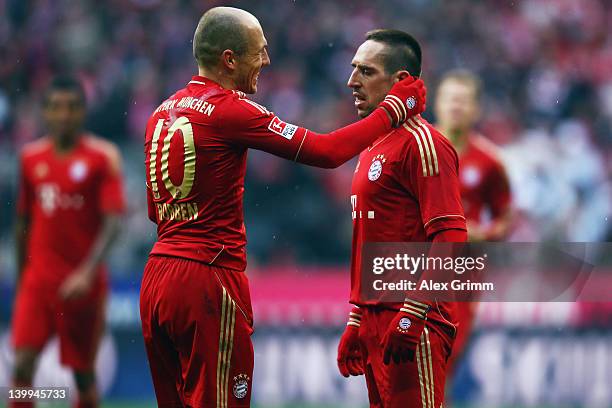 Franck Ribery of Muenchen celebrates his team's second goal with team mate Arjen Robben during the Bundesliga match between FC Bayern Muenchen and FC...