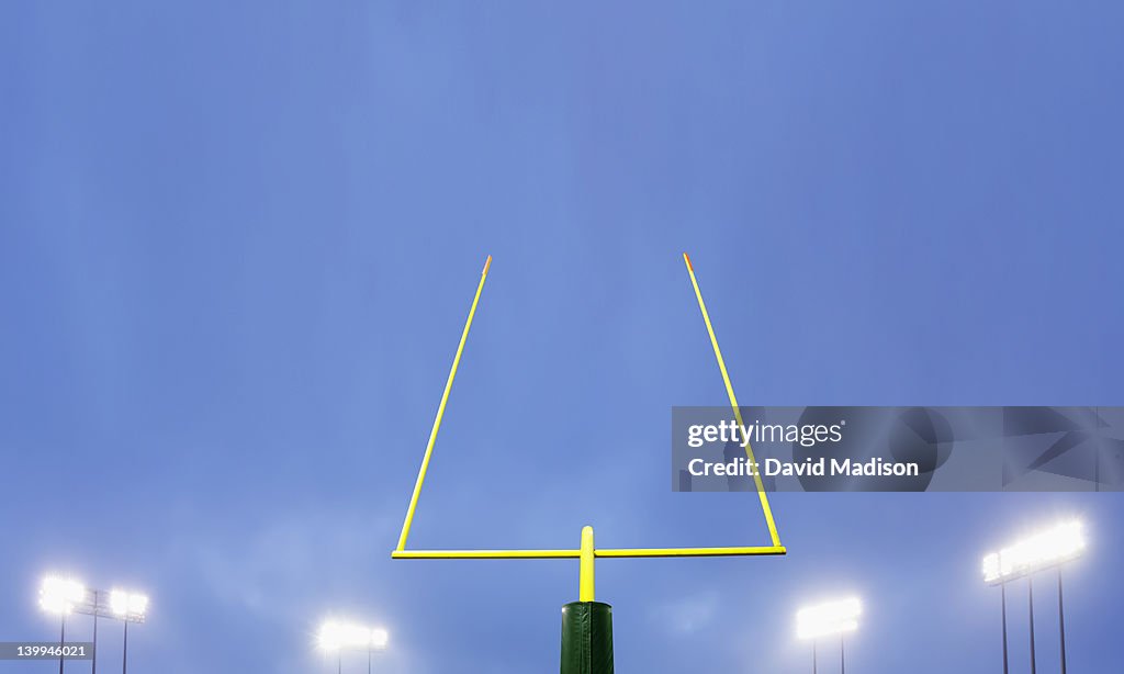 Football goalpost and stadium lights.