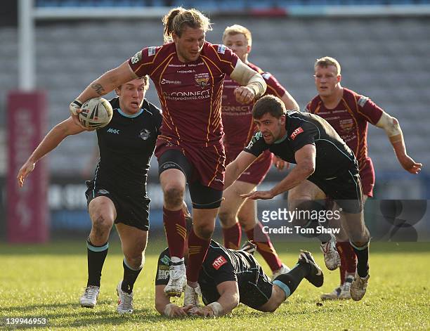 Eorl Crabtree of Huddersfield evades a tackle during the Super League match between London Broncos and Huddersfield Giants at Twickenham Stoop on...