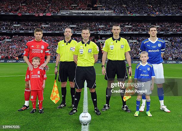Team captains Steven Gerrard of Liverpool and Mark Hudson of Cardiff City pose with mascots and match officials before the kick-off of the Carling...