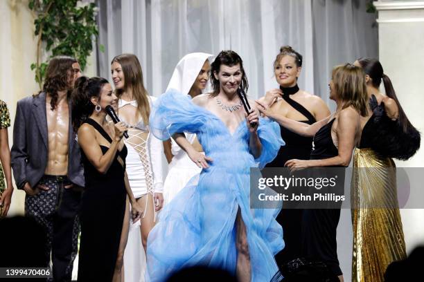 Eva Longoria, Milla Jovovich, Carine Roitfeld and models stand in the fashion show during the amfAR Cannes Gala 2022 at Hotel du Cap-Eden-Roc on May...