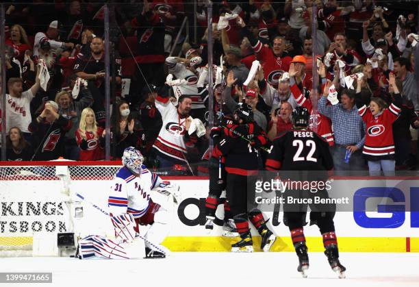 The Carolina Hurricanes celebrate a shorthanded goal by Vincent Trocheck against the New York Rangers during the first period in Game Five of the...