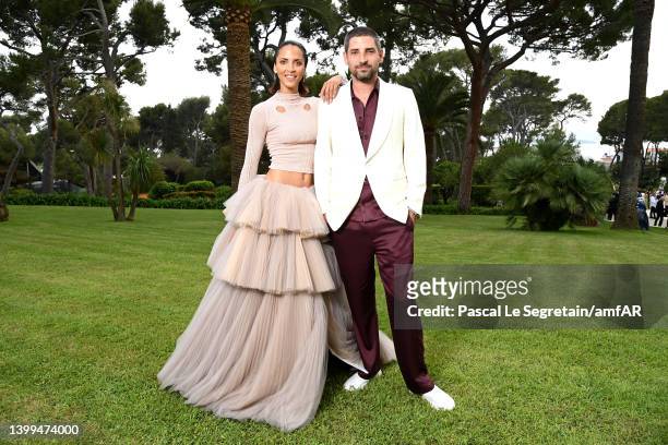 Noémie Lenoir and guest pose during the amfAR Cannes Gala 2022 at Hotel du Cap-Eden-Roc on May 26, 2022 in Cap d'Antibes, France.