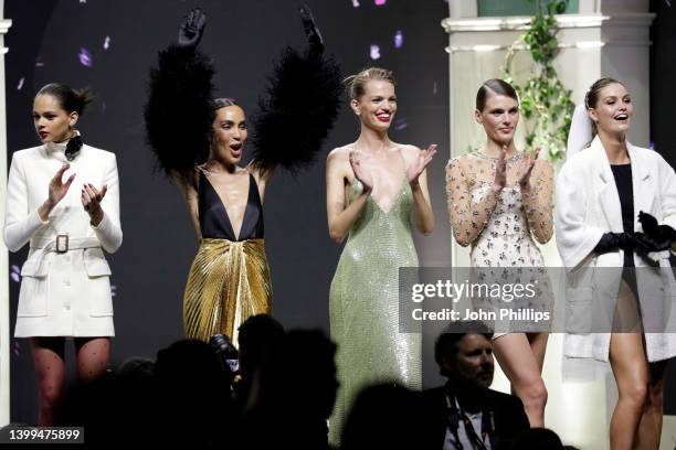 Models stand on stage in the fashion show during the amfAR Cannes Gala 2022 at Hotel du Cap-Eden-Roc on May 26, 2022 in Cap d'Antibes, France.