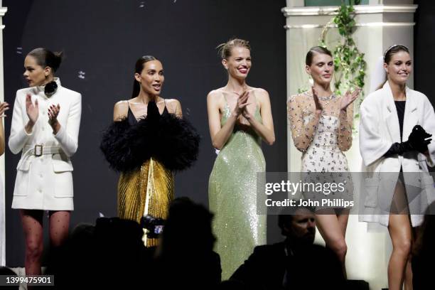 Models stand on stage in the fashion show during the amfAR Cannes Gala 2022 at Hotel du Cap-Eden-Roc on May 26, 2022 in Cap d'Antibes, France.