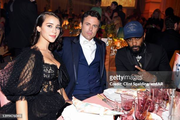 Caylee Cowan, Casey Affleck and LaKeith Lee Stanfield attend the amfAR Cannes Gala 2022 at Hotel du Cap-Eden-Roc on May 26, 2022 in Cap d'Antibes,...