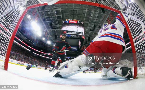 Teuvo Teravainen of the Carolina Hurricanes scores a second period powerplay goal against Igor Shesterkin of the New York Rangers as Vincent Trocheck...