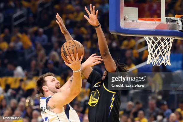 Luka Doncic of the Dallas Mavericks drives to the basket against Kevon Looney of the Golden State Warriors during the first quarter in Game Five of...