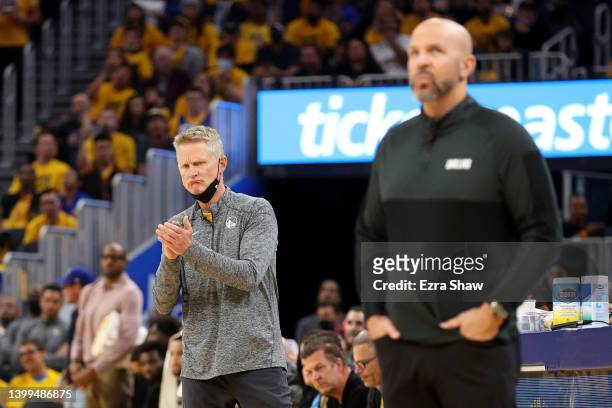 Head coach Steve Kerr of the Golden State Warriors reacts to a play as head coach Jason Kidd of the Dallas Mavericks looks on during the second...