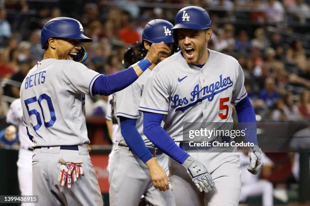 Freddie Freeman of the Los Angeles Dodgers reacts with teammate Mookie Betts after Freeman's three-run home run during the second inning against the...