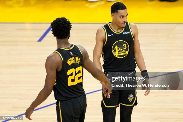 Jordan Poole and Andrew Wiggins of the Golden State Warriors react to a play during the second quarter against the Dallas Mavericks in Game Five of...