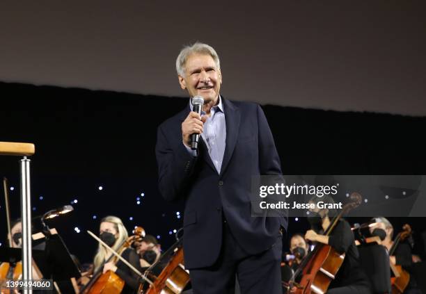 Harrison Ford of the upcoming fifth installment of the “Indiana Jones” franchise honors composer John Williams on his 90th birthday at Star Wars...