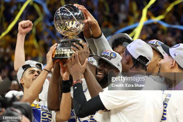 Draymond Green of the Golden State Warriors holds the Western Conference Champion trophy after the 120-110 win against the Dallas Mavericks in Game...