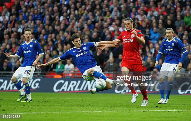 Mark Hudson of Cardiff City challenges Andy Carroll of Liverpool during the Carling Cup Final match between Liverpool and Cardiff City at Wembley...