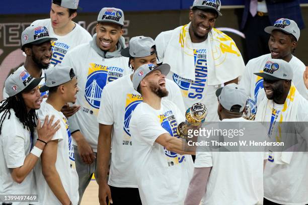 Stephen Curry of the Golden State Warriors celebrates with teammates after winning the Magic Johnson Western Conference Finals MVP award after a...