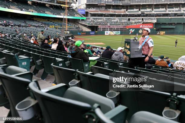 Hot dog vendor Hal Gordon sells hot dogs as the Oakland Athletics play the Texas Rangers at RingCentral Coliseum on May 26, 2022 in Oakland,...
