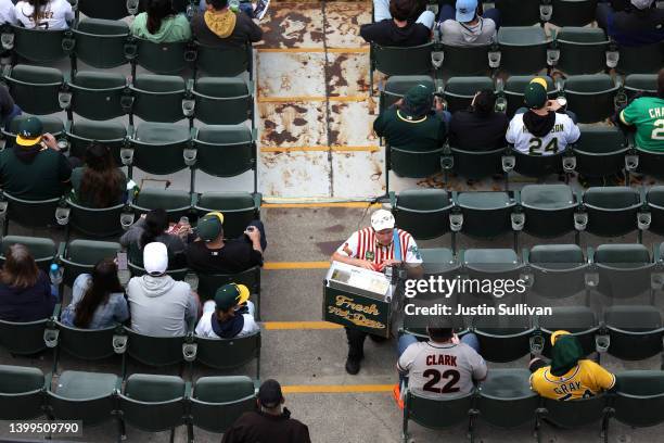 Hot dog vendor Hal Gordon sells hot dogs as the Oakland Athletics play the Texas Rangers at RingCentral Coliseum on May 26, 2022 in Oakland,...