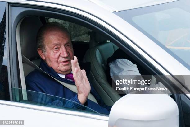 King Emeritus Juan Carlos I waves from a vehicle as he leaves his house in Sanxenxo on his way to Madrid, on 22 May, 2022 in Sanxenxo, Pontevedra,...