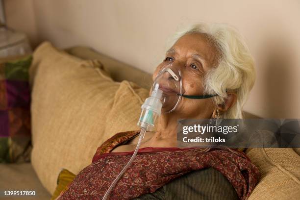 old woman with oxygen mask - breathing problems stock pictures, royalty-free photos & images