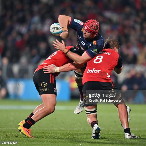 Harry Wilson of the Reds offloads the ball during the round 15 Super Rugby Pacific match between the Crusaders and the Queensland Reds at...