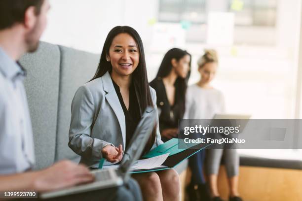 multiracial young woman sits to discuss with work colleagues plans and ideas in modern coworking shared business office - interview candidate stock pictures, royalty-free photos & images
