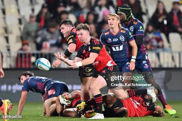 Mitchell Drummond of the Crusaders passes the ball during the round 15 Super Rugby Pacific match between the Crusaders and the Queensland Reds at...