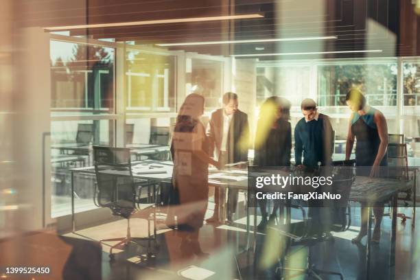 business colleagues meet together to discuss ideas in a modern conference room reflection in glass - flerdubbel exponering bildbanksfoton och bilder