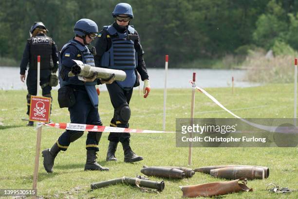 Ukrainian bomb disposal experts and de-mining teams clear a lake and field of unexploded munitions and mines in Horenka suburb on May 27, 2022 in...