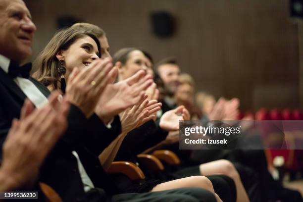 excited audience clapping in the theater - gala reception stock pictures, royalty-free photos & images