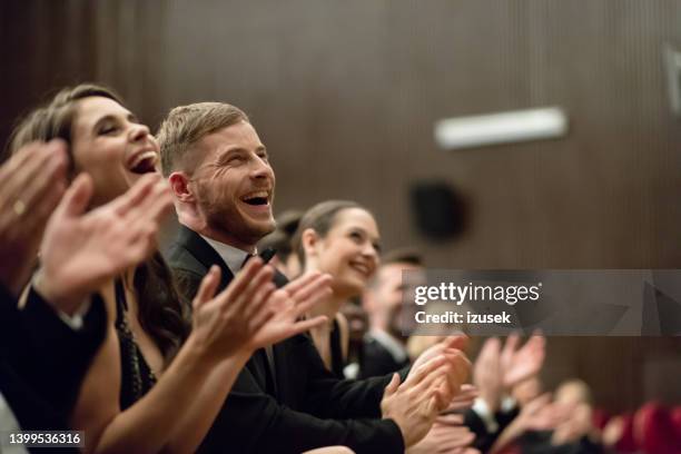 excited audience clapping in the theater - gala dinner stock pictures, royalty-free photos & images