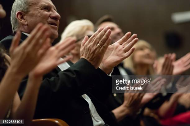 spectators clapping in the theater, close up of hands - theater gala stock pictures, royalty-free photos & images