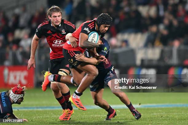 Chay Fihaki of the Crusaders is tackled during the round 15 Super Rugby Pacific match between the Crusaders and the Queensland Reds at Orangetheory...