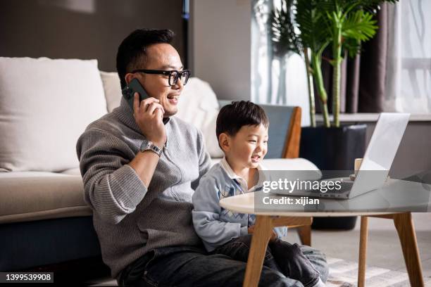 father with his son working together at home - chinese couple computer bildbanksfoton och bilder