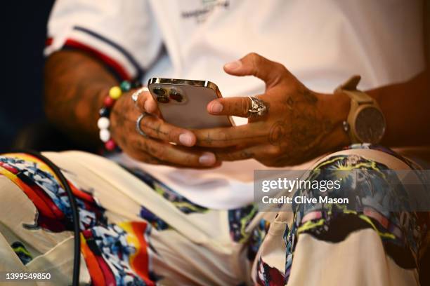 Detail shot of Lewis Hamilton of Great Britain and Mercedes using his mobile phone in the Drivers Press Conference prior to practice ahead of the F1...